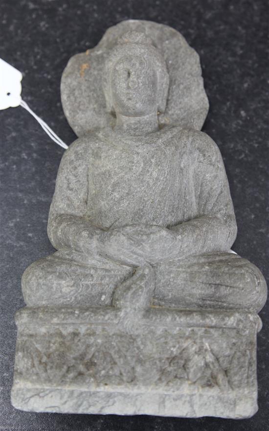 A Gandharan grey schist seated figure of Buddha, 2nd-4th century AD height 25.5cm